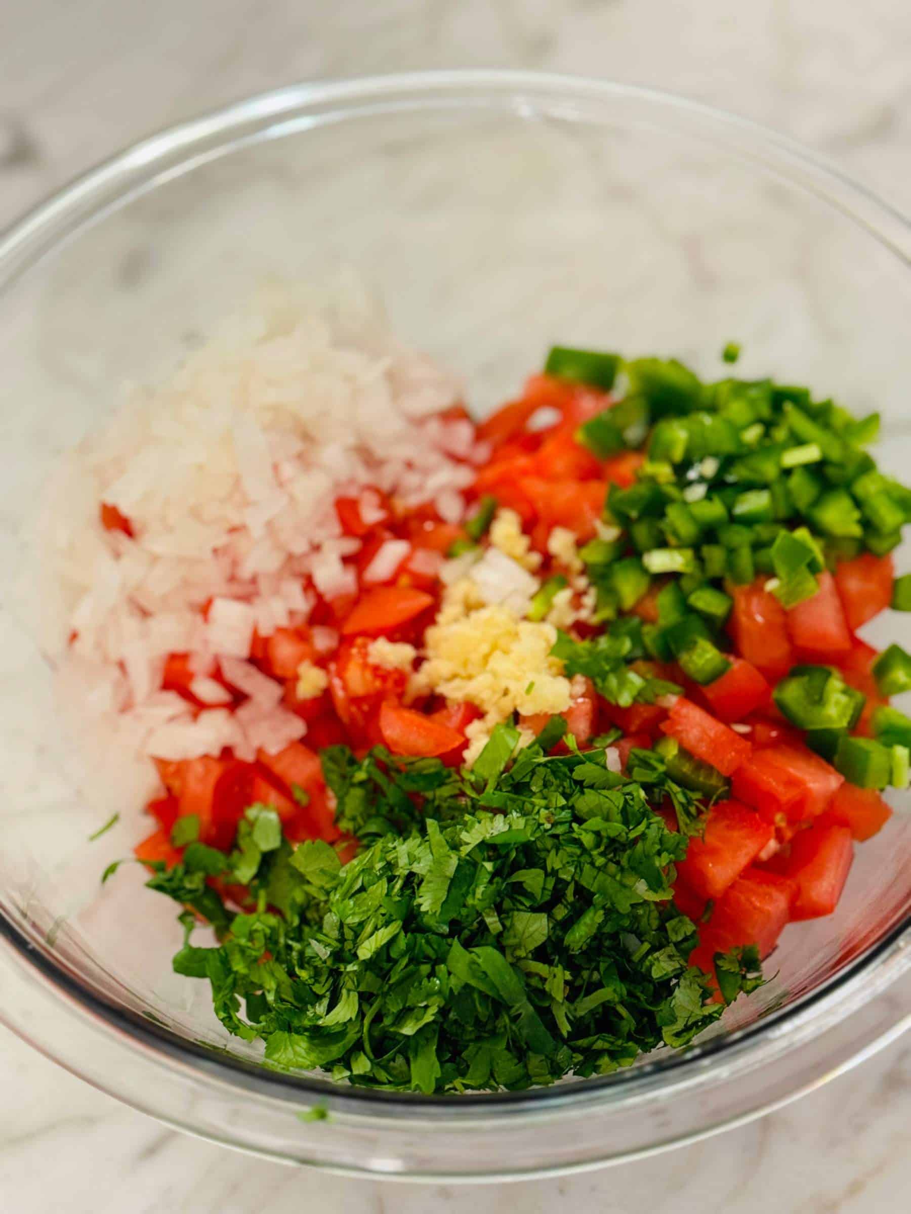 Pico de gallo ingredients in glass bowl