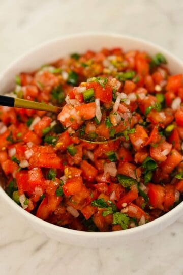 White bowl with Pico de Gallo with Golden Spoon